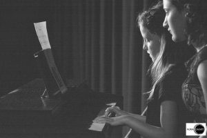 Niña tocando el piano en concierto